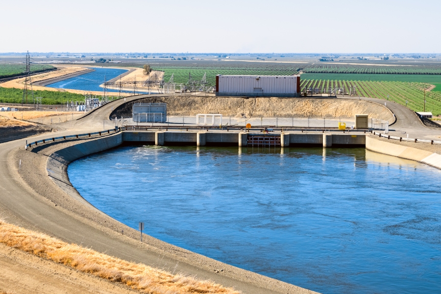 a pumping plant pushes water up hill on a canal, part of the california aqueduct system in central California