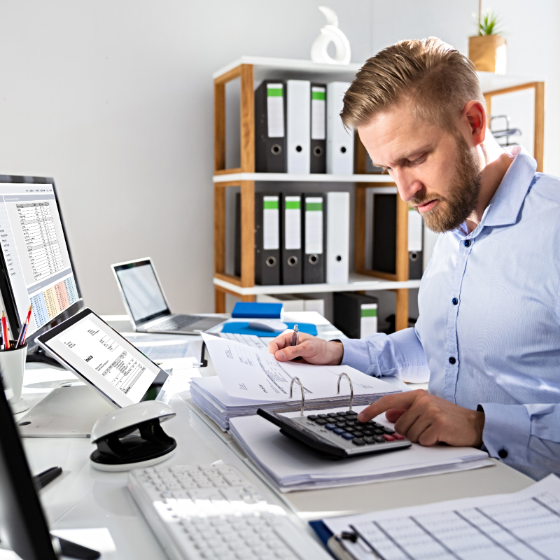 male admin assistant working on a computer spreadsheet