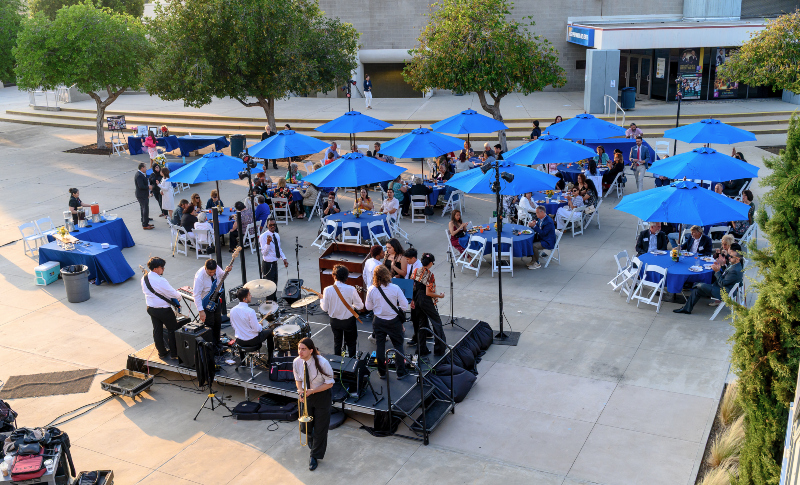 A catered, outdoor dining experience with live music taking place just outside the Visual Arts Building