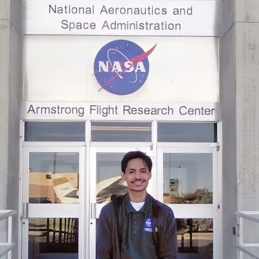 Matthew Levitt standing in front of NASA's Armstrong Flight Research Center