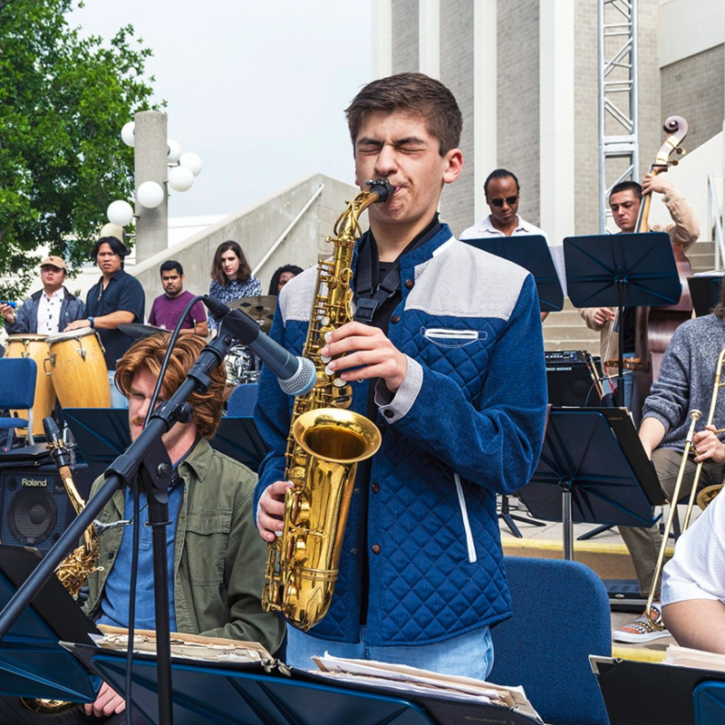 Nathan Palmer playing saxophone with the campus jazz orchestra